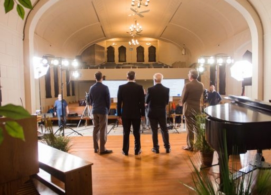 four people standing on stage